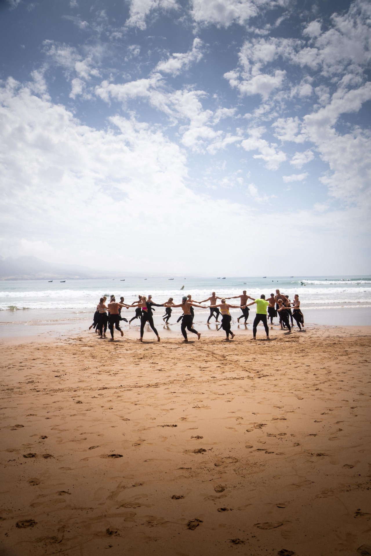 Surf group warming up together on the beach